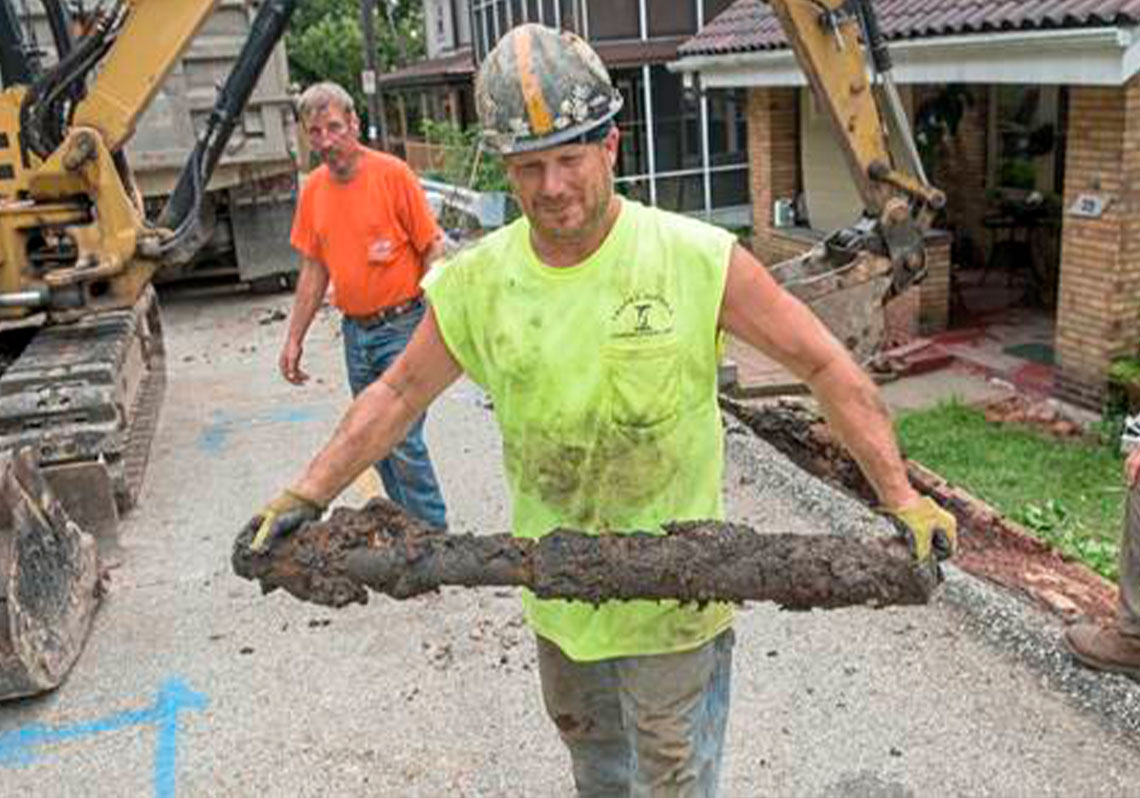 Workers pull out old lead pipe in Pittsburgh
